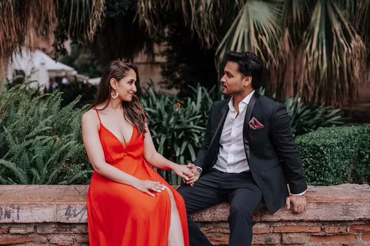 Elegant couple holding hands during a private photoshoot in a lush garden setting in Marbella.
