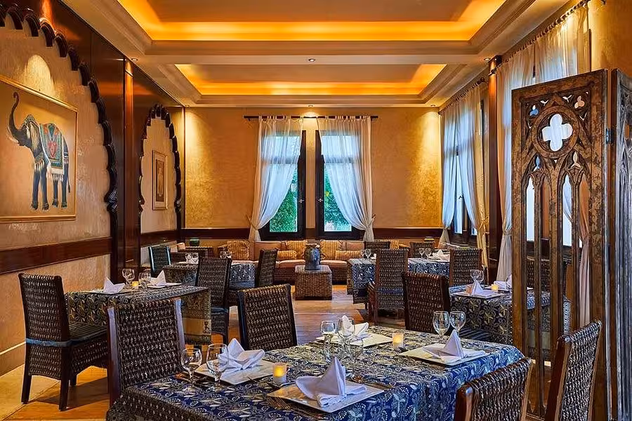 Elegant dining area in Hurghada Egypt with ornate decor, ambient lighting, and beautifully set tables for fine dining.