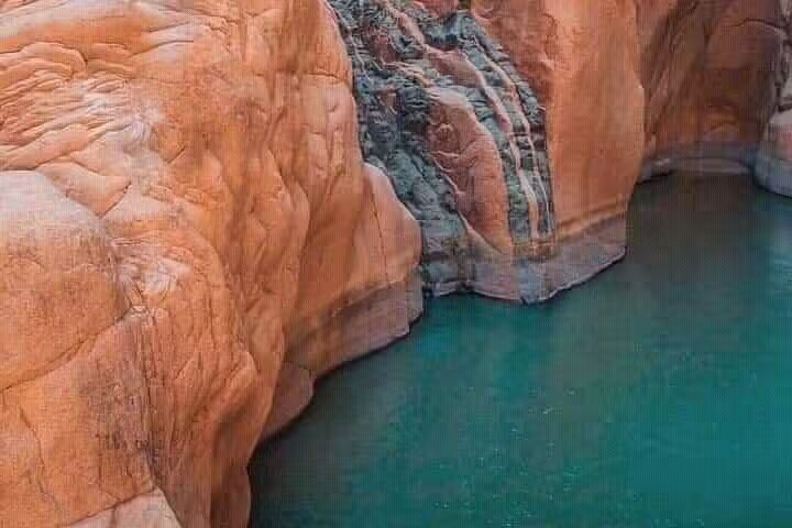 Emerald Lost Lake water beneath rugged Sinai rock walls, scenic stop on private Jeep safari tour from Sharm El Sheikh