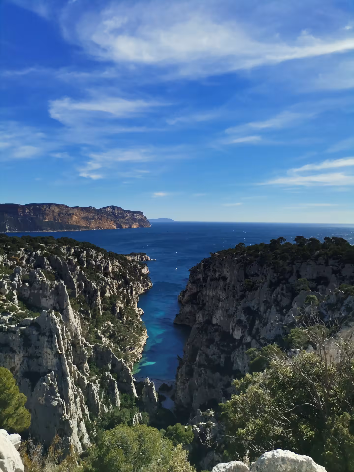 Panoramic hike above En-Vau Calanque, with dramatic white cliffs and blue sea in Calanques National Park Cassis