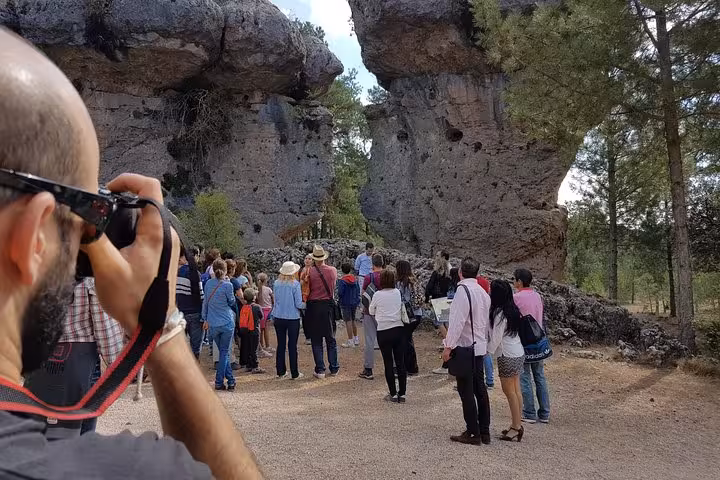Tour group viewing towering rock formations in Enchanted City near Cuenca on Ventano del Diablo trip