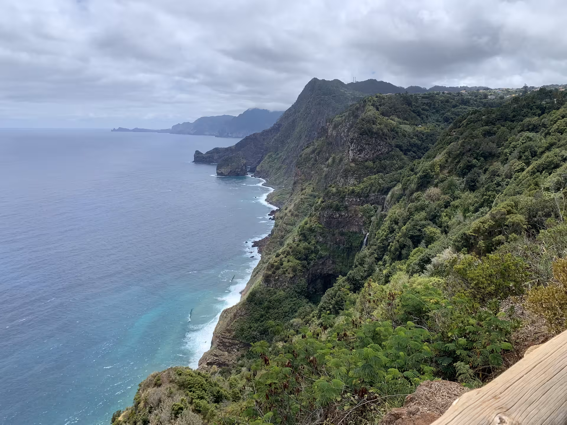 Stunning coastal cliffs and azure ocean waves on The Enchanted East Tour highlight natural beauty.