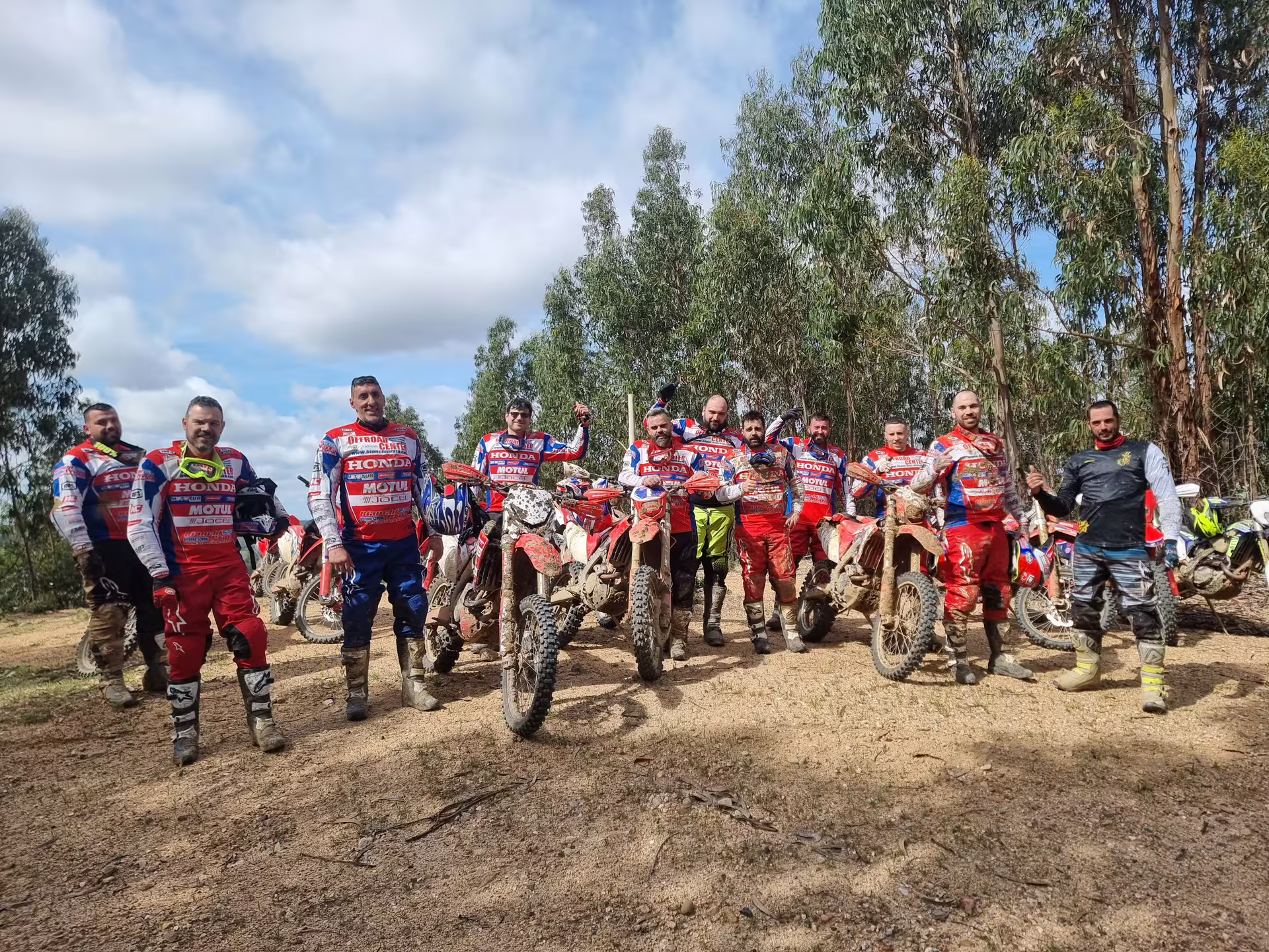 Group of dirt bikers in vibrant gear ready for the 3-hour Enduro Tour in Carregado, Lisbon forest trails.