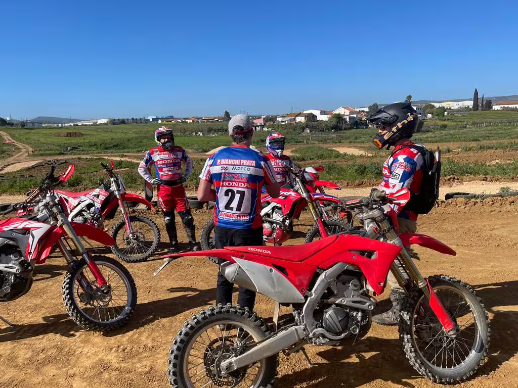 Enduro riders in protective gear prepare for a challenging off-road adventure in the scenic trails of Carregado, Lisboa.