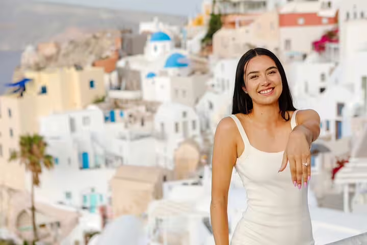 Engagement ring reveal in Oia Santorini, surprise proposal photo session with iconic white houses backdrop