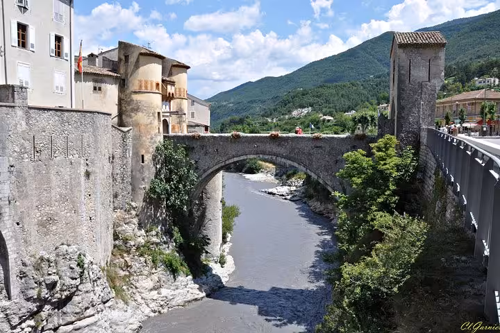 Scenic stone bridge over a river in Entrevaux, featured in the Fabulous Red Canyon and Entrevaux full day tour.