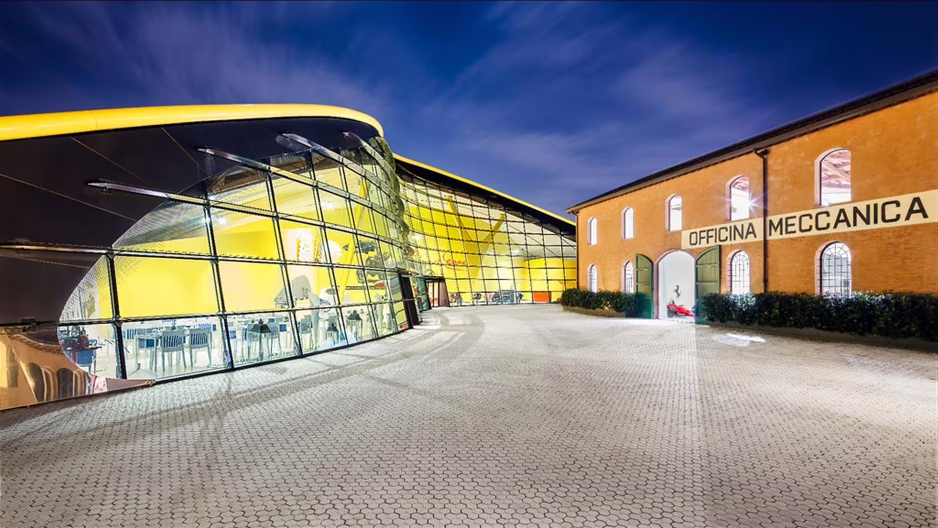 Enzo Ferrari Museum Modena exterior at night, iconic glass building included with Bologna Lamborghini and Ferrari ticket