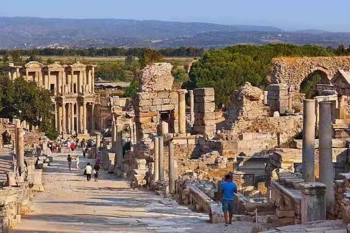 Scenic view of the ancient ruins of Ephesus with tourists exploring during a private tour from Kusadasi Port.