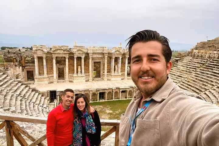 Travelers selfie at Ephesus ancient theater with Roman ruins, highlight of 5-day guided Turkey tour