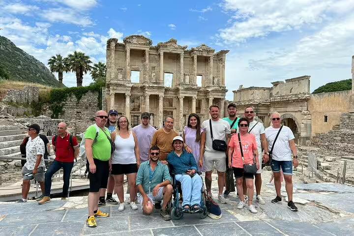 Visitors exploring the iconic ruins of Ephesus' Celsus Library on a guided tour from Kusadasi Port.