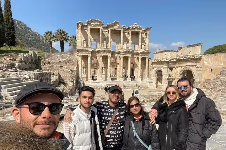 Visitors capture memories at Ephesus, featuring the iconic Library of Celsus on a day tour from Istanbul.