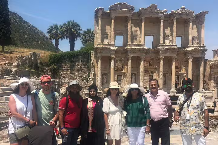 Visitors pose in front of the ancient Ephesus Library on a guided day tour from Istanbul with flights, capturing the ancient allure.