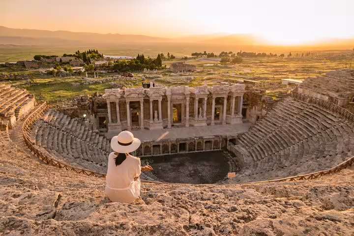 Traveler enjoys sunset view over the ancient Roman theater in Hierapolis, Pamukkale, on Ephesus & Pamukkale tour.