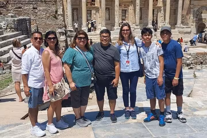 Small group Ephesus shore excursion from Kusadasi, travelers posing by ancient ruins and columns
