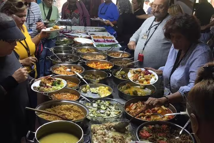 Guests serving Turkish buffet lunch during private Ephesus and Sirince Village half-day tour, all-inclusive experience