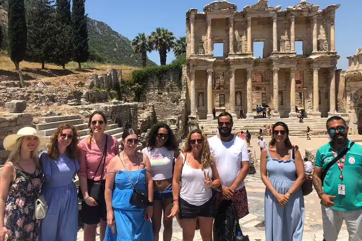 Tour group posing in front of the ancient Library of Celsus during an Ephesus day tour from Istanbul with flights.