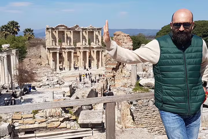 Traveler posing by the Library of Celsus on an Ephesus tour from Izmir, exploring ancient ruins in Turkey