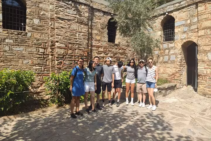 Small group photo at the House of Virgin Mary courtyard, part of an Ephesus tour from Kusadasi day trip