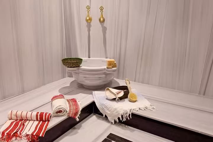 Marble hammam wash area with peshtemal towels and scrub tools, included in private Ephesus tour