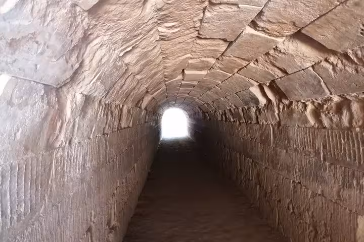 Stone-lined ancient tunnel passage at Epidaurus archaeological site on a private luxury tour from Nafplio