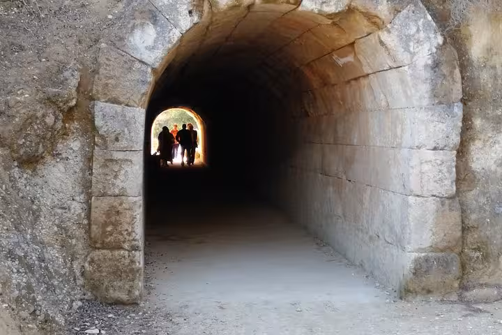 Stone tunnel passage at Ancient Epidaurus archaeological site, part of Nafplio and Corinth Canal private tour