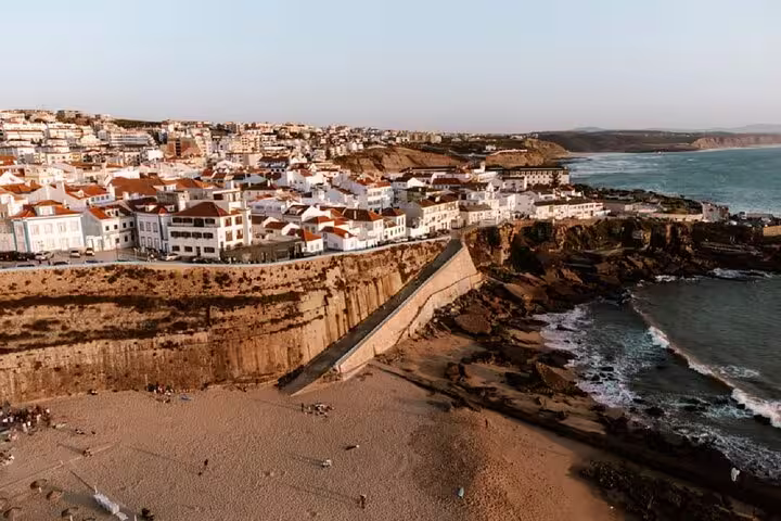 Aerial view of Ericeira’s stunning coastline with whitewashed buildings and sandy beaches, featured in the Mafra, Ericeira & Queluz private day tour.