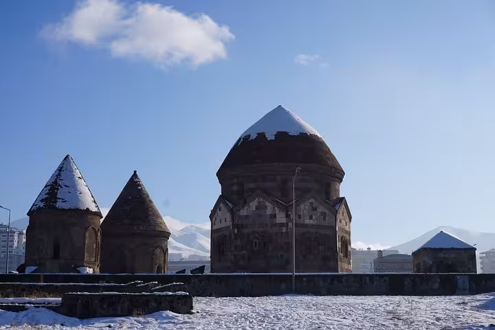 Snowy Erzurum Three Tombs (Uc Kumbetler) under blue sky, winter stop on a private 2-day guided tour