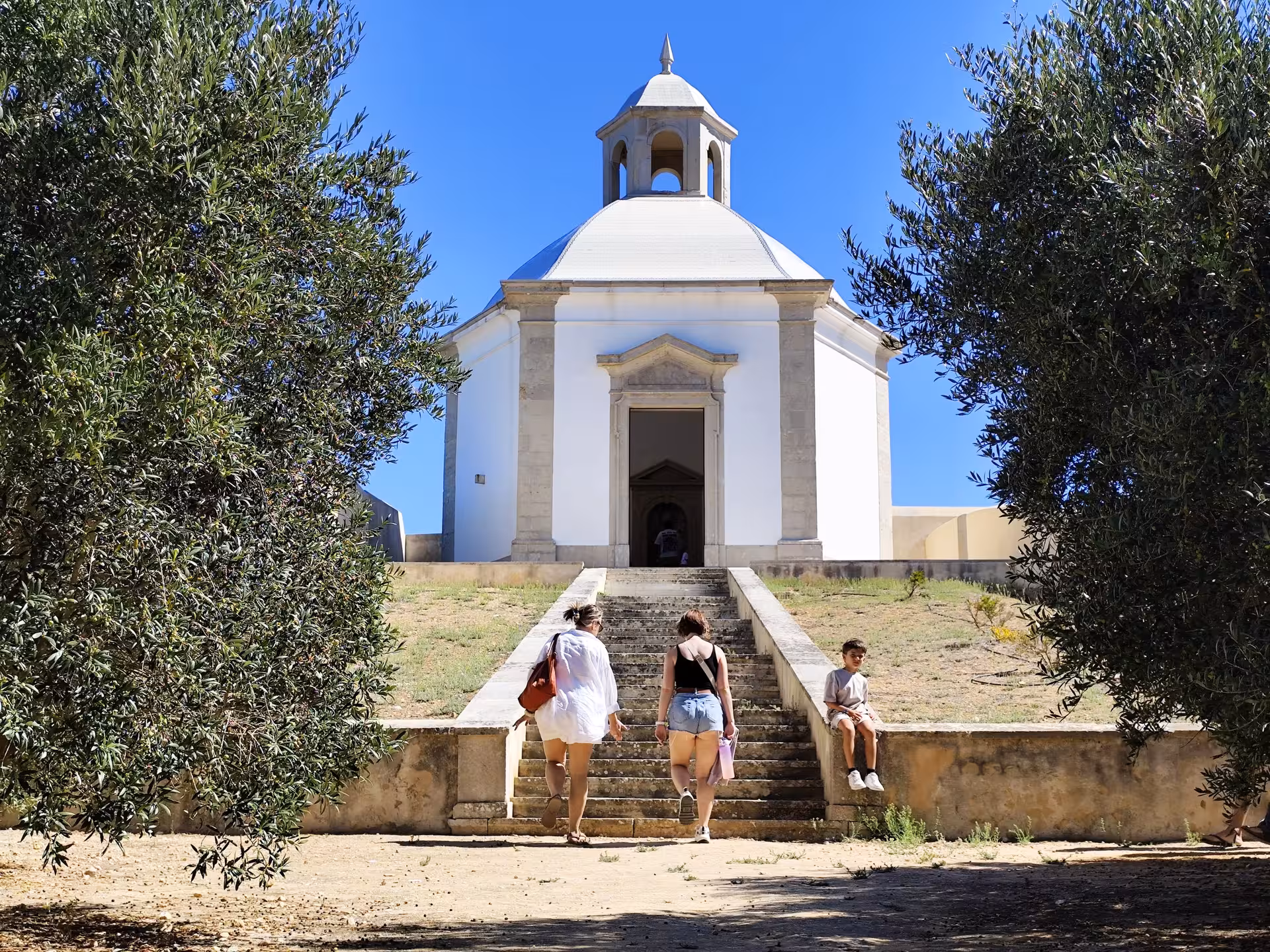 Visitors climbing steps to Nossa Senhora do Cabo Espichel sanctuary on the Wild Cabo Espichel tour