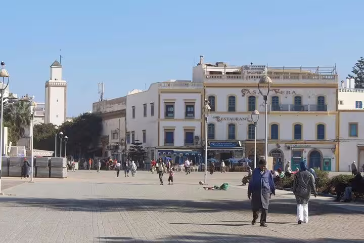 Essaouira main square with whitewashed buildings and pedestrians, a popular stop on Marrakech day trip tour