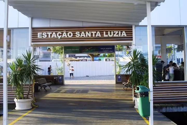 The entrance of Estação Santa Luzia, a key departure point for shuttle transfers to Paraty, framed by tropical plants.