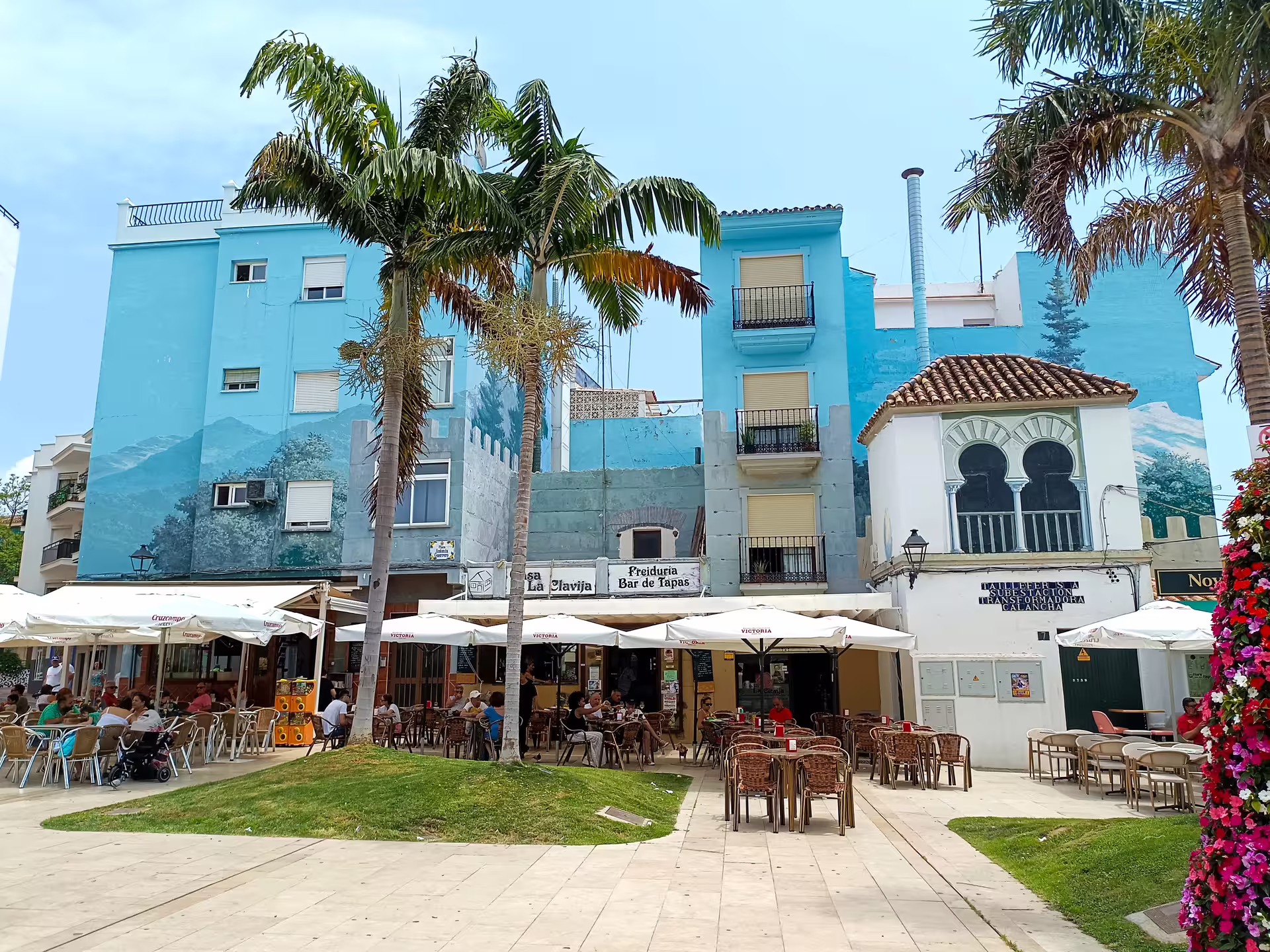 Estepona old town plaza with palm trees and outdoor tapas terraces on a private Casares day trip with pickup