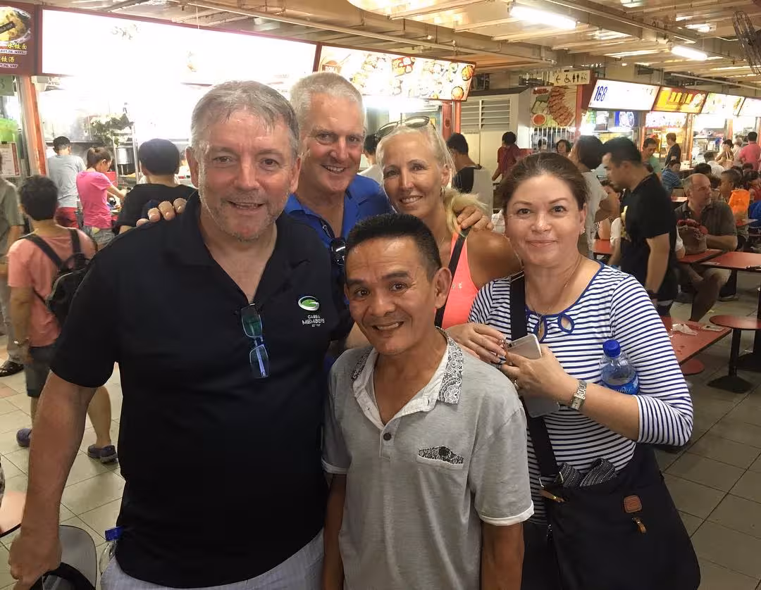 Visitors at a lively food market, showcasing cultural diversity and street food exploration on the neighborhood tour.