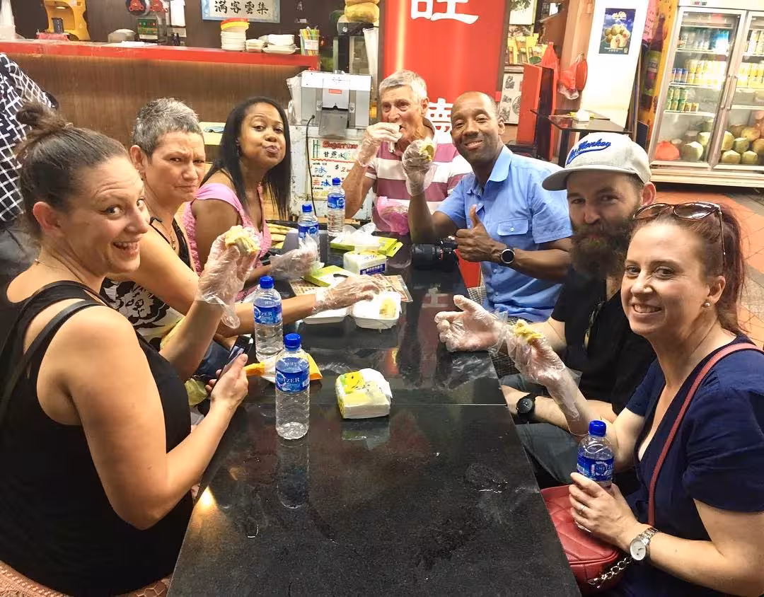 Tourists enjoying diverse street food sampling on UNESCO food tour.
