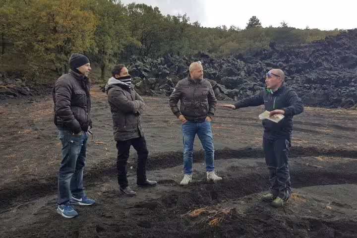 Guide briefing guests on Etna volcanic landscape during full-day Etna Jeep tour from Taormina with lunch