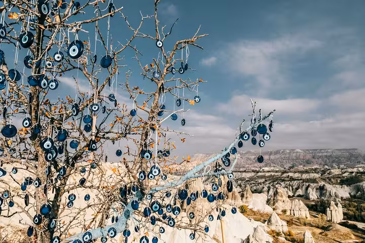 Evil eye charms hanging on trees above Cappadocia valleys, scenic stop on 5-day Turkey itinerary