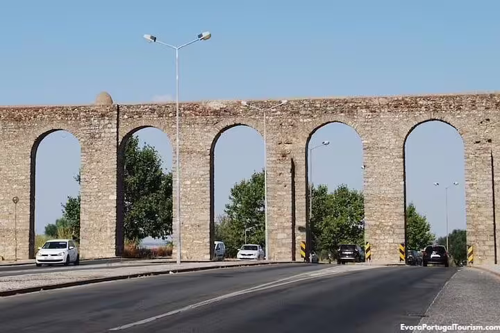 Evora Aqueduct arches over the road in Alentejo, a key stop on the Explore Evora GPS audio tour