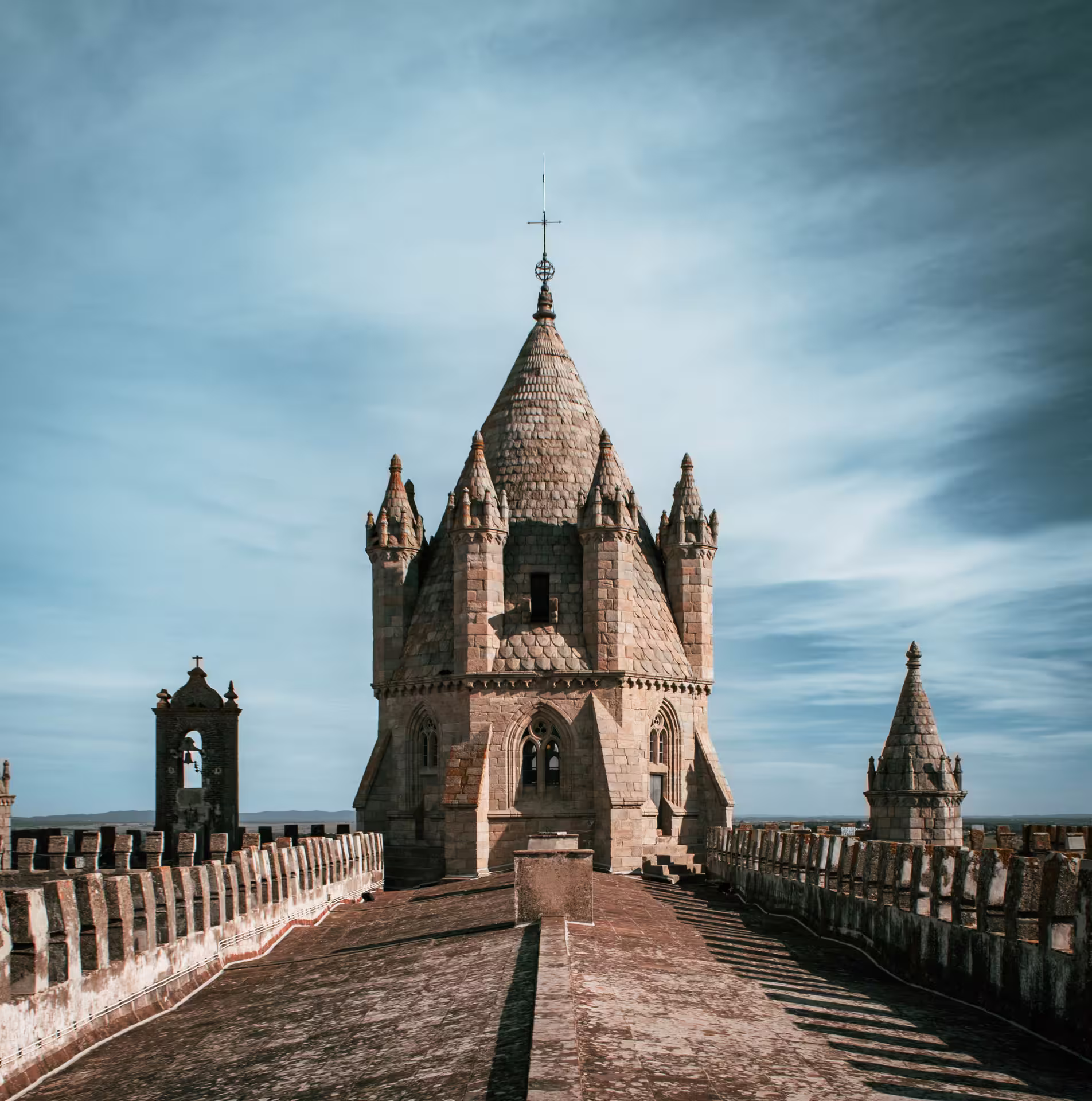 Gothic architecture of Évora Cathedral's rooftop under a clear sky, a highlight of the Wines & Wonders of Alentejo tour.