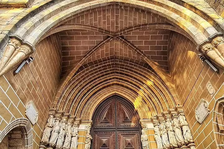 Gothic archway of Évora Cathedral, showcasing intricate stone carvings, featured in Évora Essentials full-day tour from Lisbon.