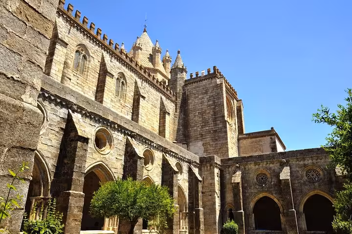 Gothic cloisters of Évora Cathedral under a clear blue sky, offering a serene spot for private guided tours.