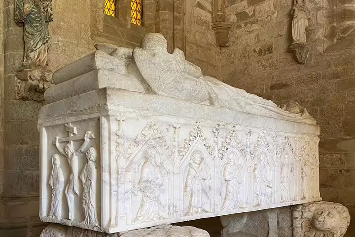 Intricately carved marble tomb in Évora's cathedral, highlighting historical artistry on a private tour from Lisbon.