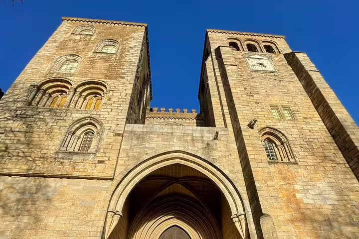Close-up of the majestic façade of Évora Cathedral, highlighting its impressive Romanesque and Gothic features.