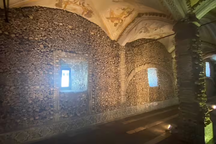 Évora's Chapel of Bones interior with bone-covered walls, offering a unique historical experience on a tour from Lisbon.
