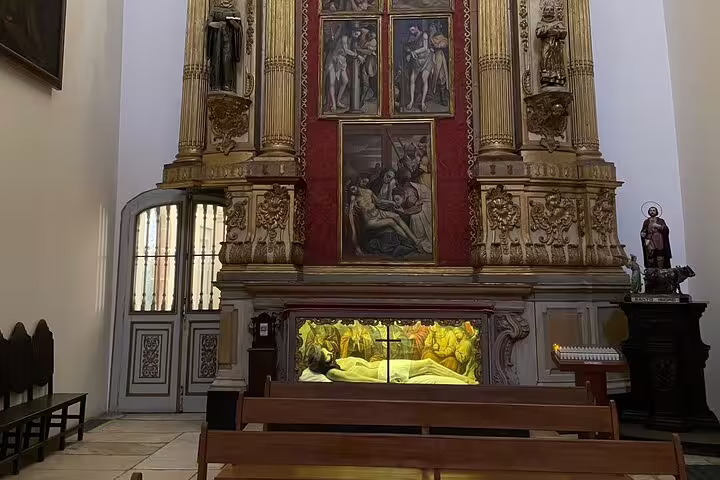 Ornate chapel interior in Évora featuring religious art and sculptures, part of the megalithic tour experience.