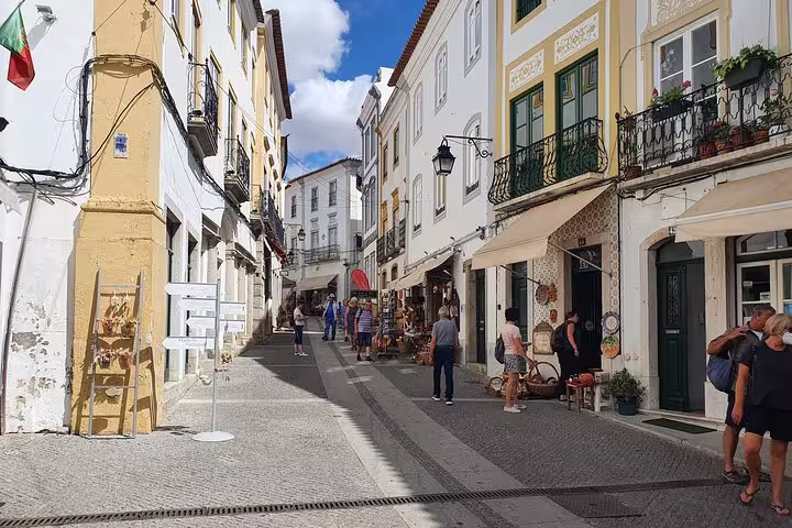 Charming street in Évora with colorful buildings and local shops, perfect for exploring on the Lisboa to Monsaraz private tour.