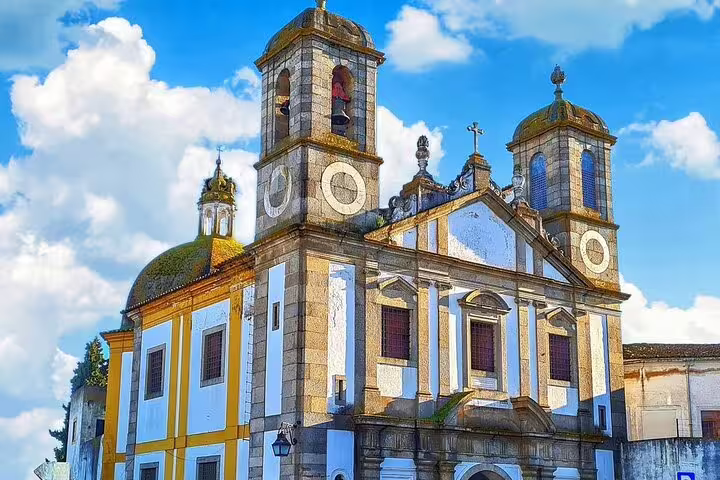 Historic Évora church under blue skies, part of Évora Essentials full-day tour from Lisbon, showcasing Portugal's rich heritage.