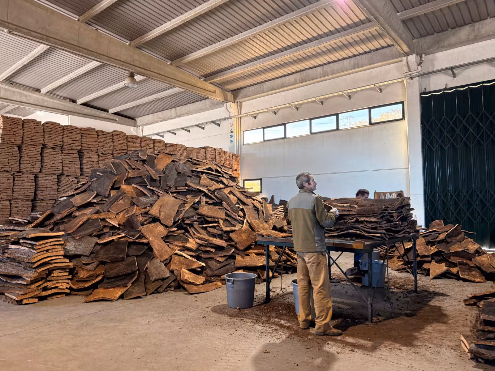 Cork processing at a warehouse in Évora, showcasing the traditional craft during a private tour of culture and wines.