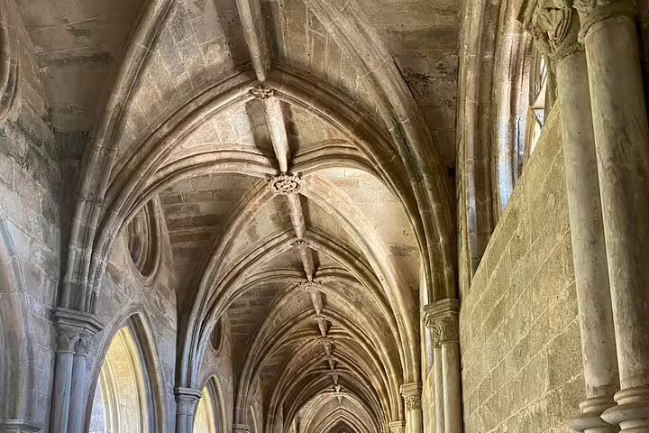 Gothic arches and stone columns in a historic church in Évora, showcasing architectural beauty on a guided day trip from Lisbon.