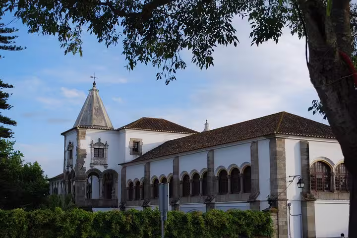 Historic architecture in Évora, Portugal, showcasing a traditional building with arched windows and a tiled roof under a clear sky.