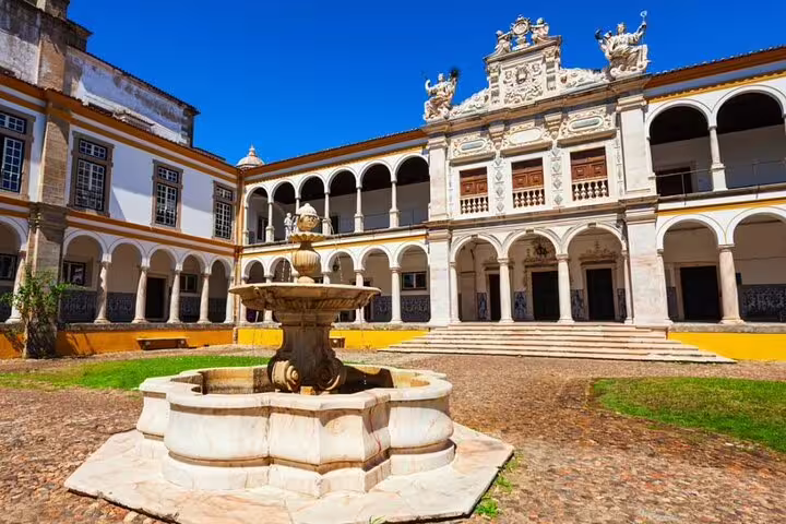 Historic courtyard in Évora, featuring a classic fountain and ornate architecture, perfect for a private day tour from Lisbon.