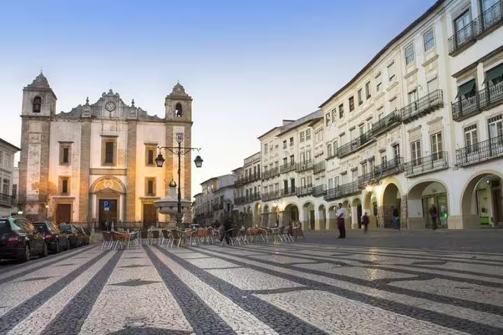 Historic town square in Évora, Portugal, featuring traditional architecture and a vibrant atmosphere on a private tour from Lisbon.